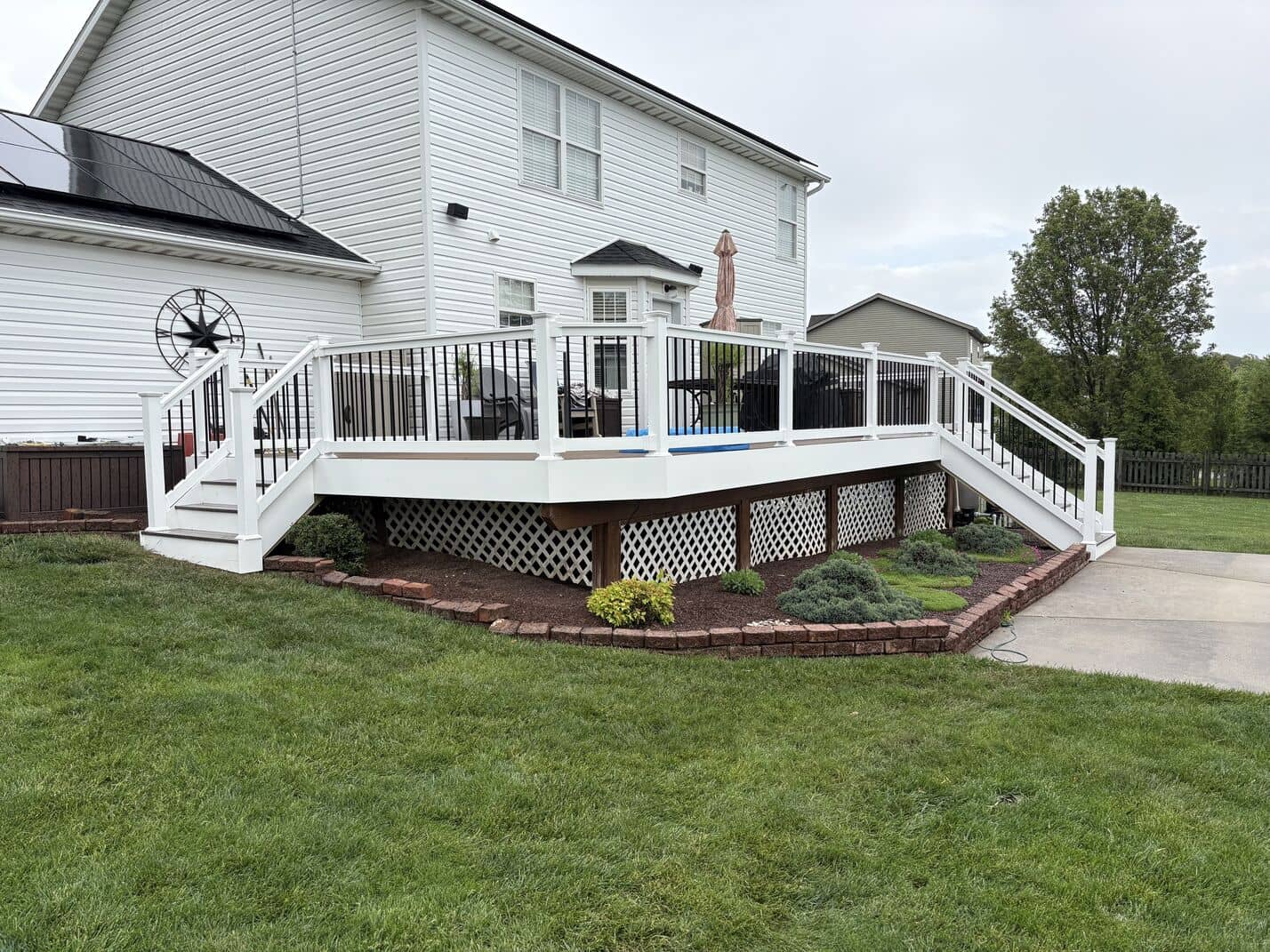 deck attached to back of house, built with composite materials and viynl railings
