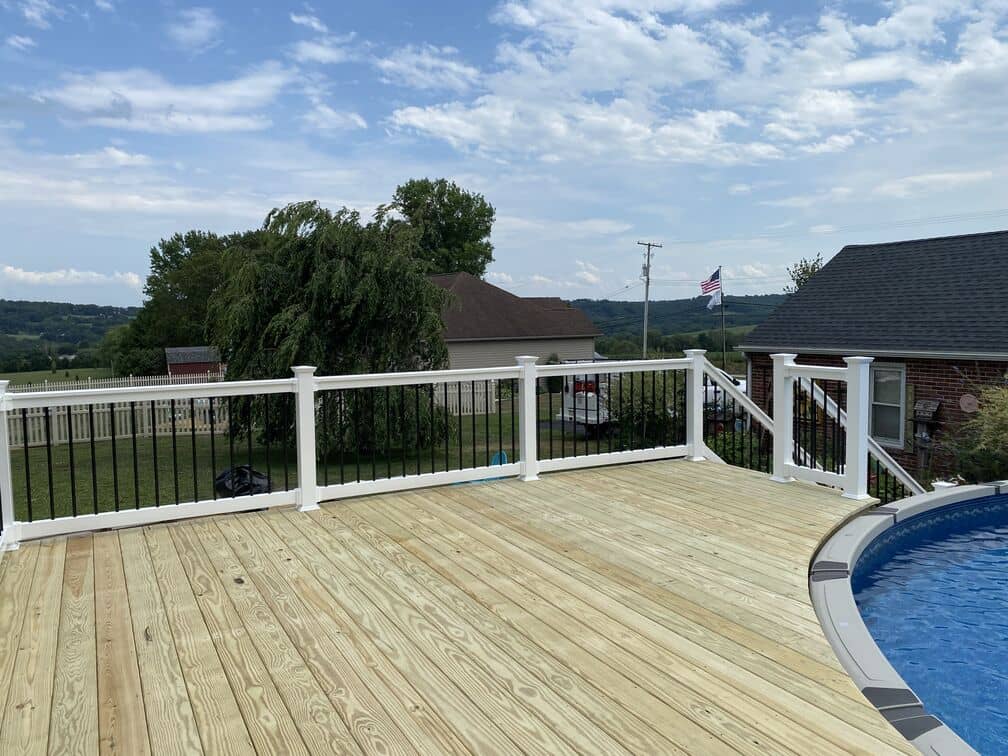 deck built out of wooden materials next to this pool